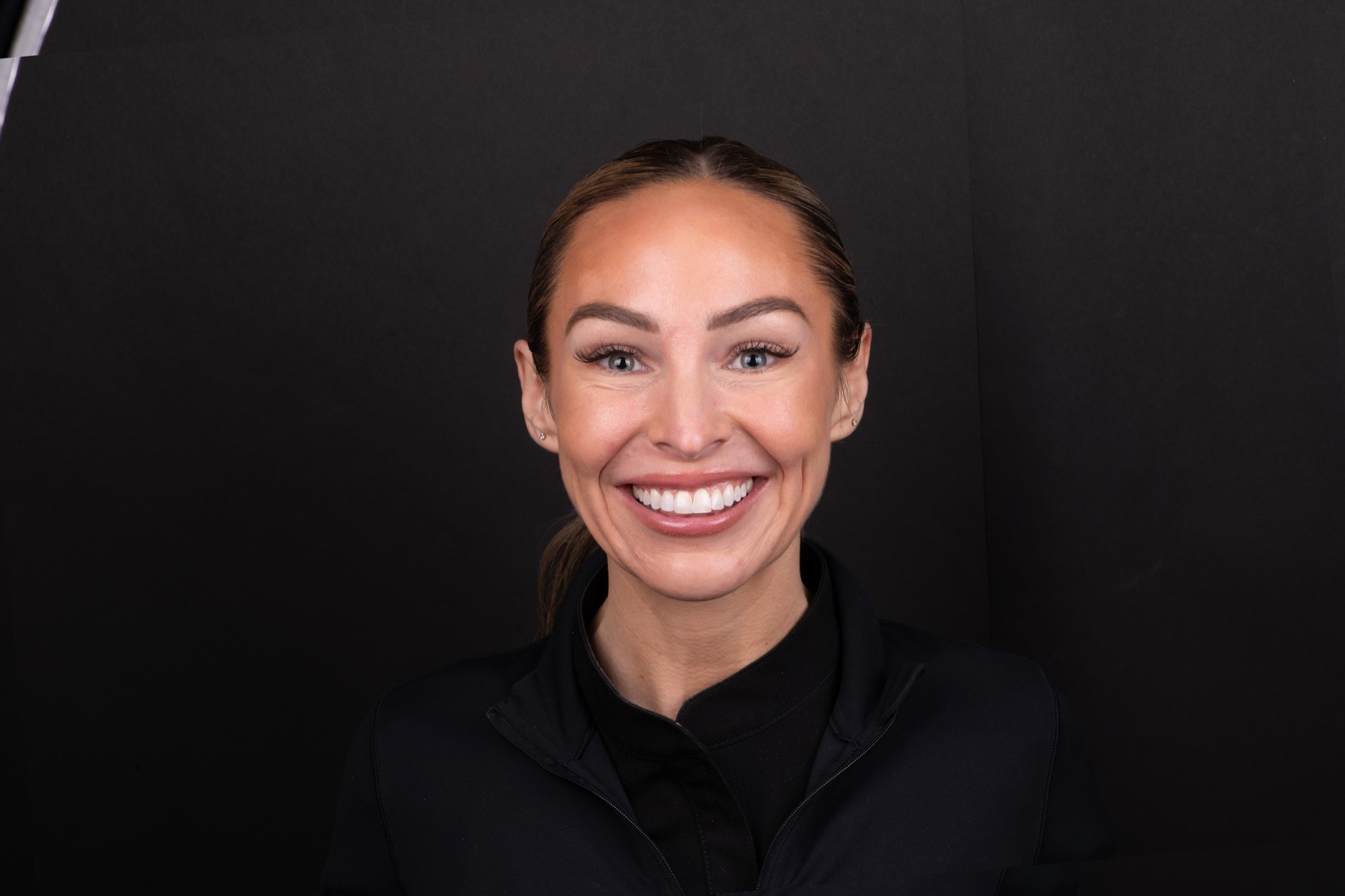 Patient portrait showing a confident smile after non-invasive veneer treatment
